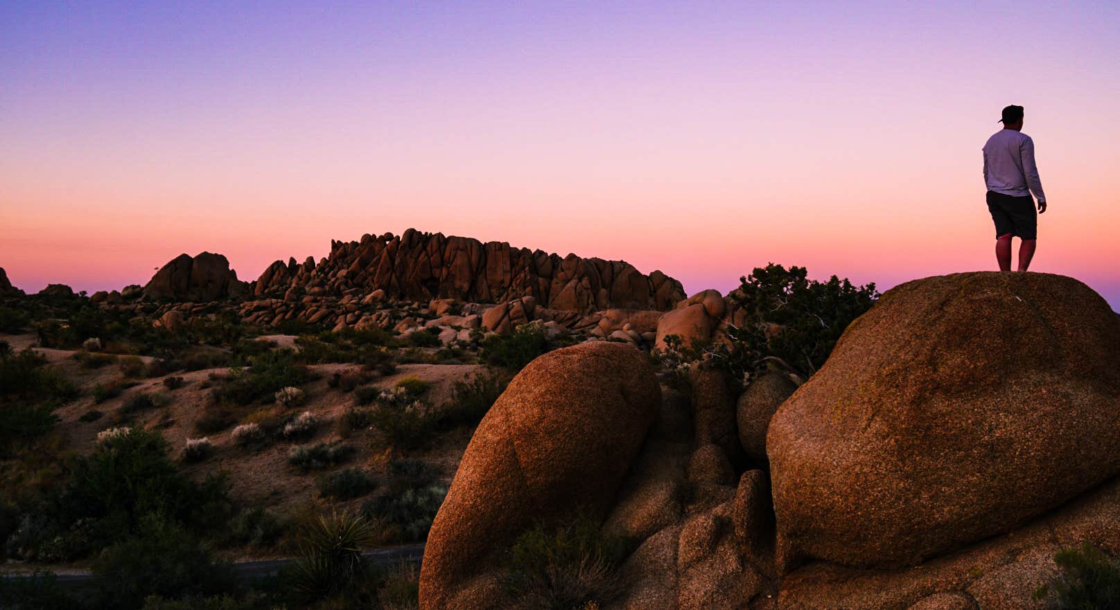 Guy Exploring Rocks in Evening at Jumbo Rocks Campground, Joshua Tree National Park