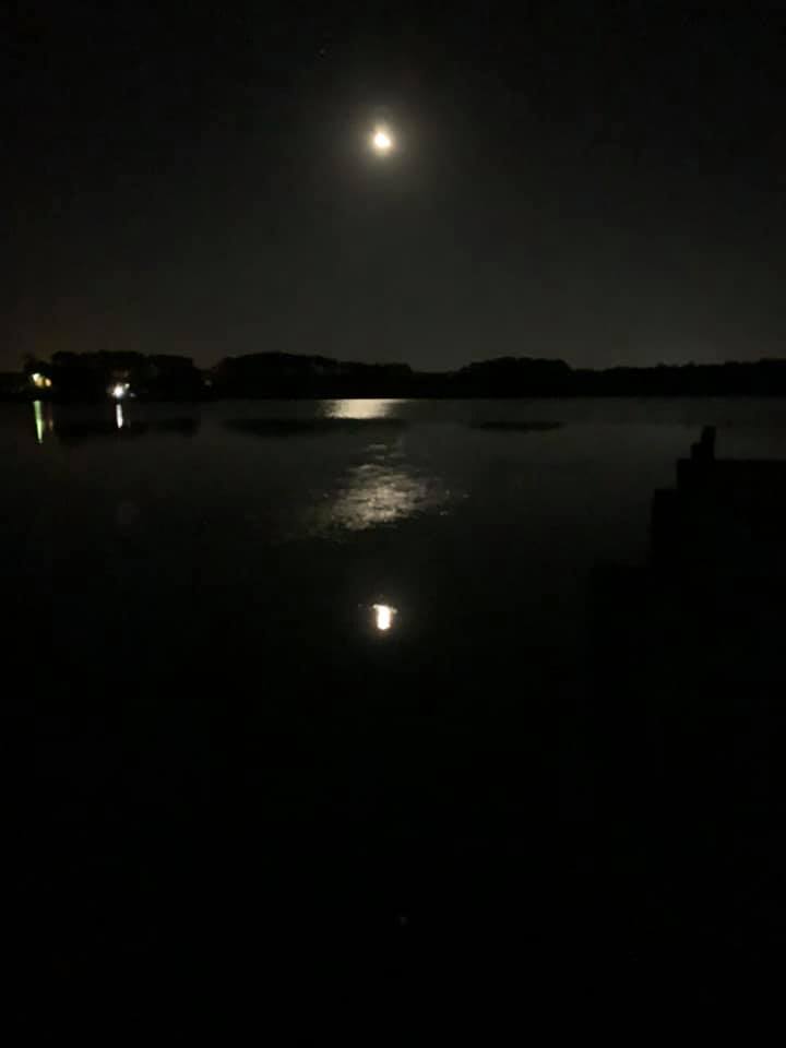 Moon over their dock on the sound