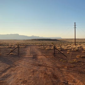 Gate from outside, facing down the road to the canyon edge