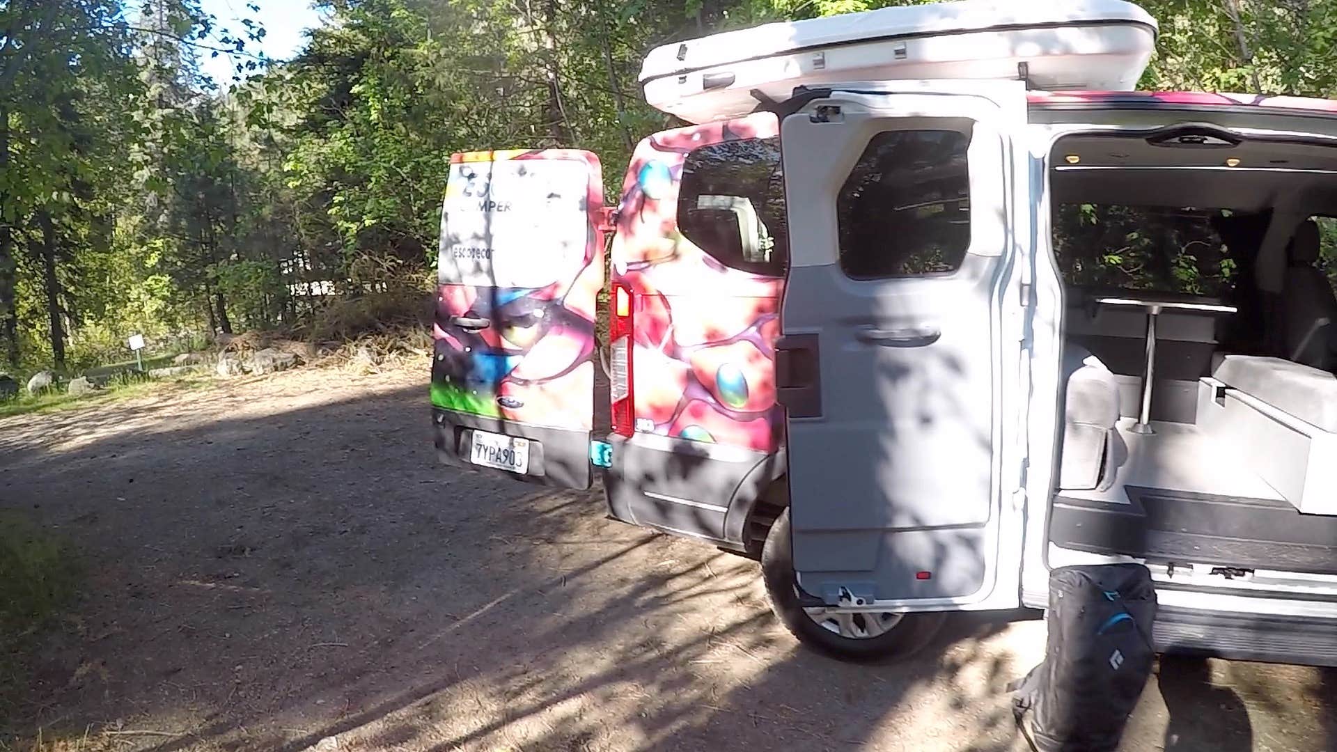 From the back of the campervan onto the road leading down to the campsite and the trail to the river.
