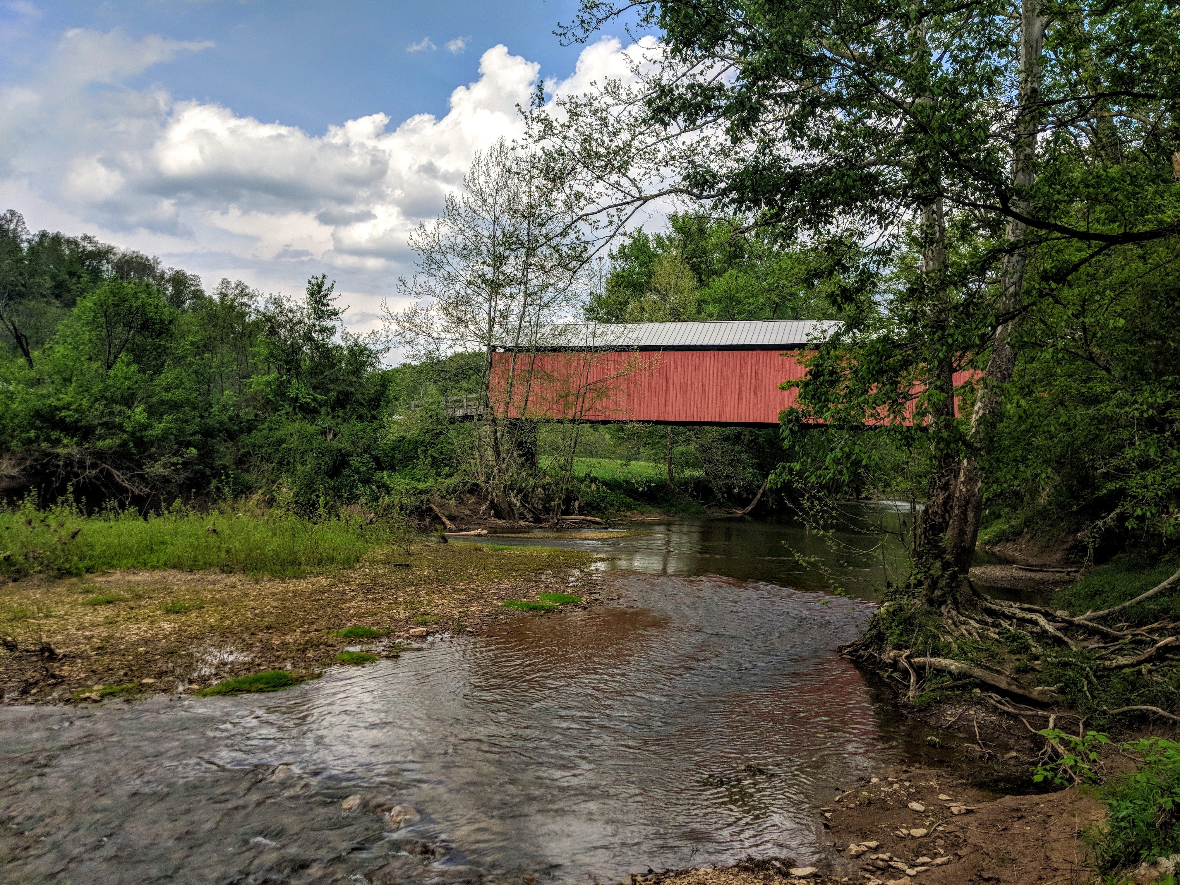 View of the covered bridge from the bank of the river.