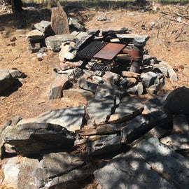 Someone made chairs for the fire out of flat stones from the lake.