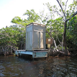 Dock with porta-potty at lard can. Canoe grounding is in the mangroves to the right of the dock.