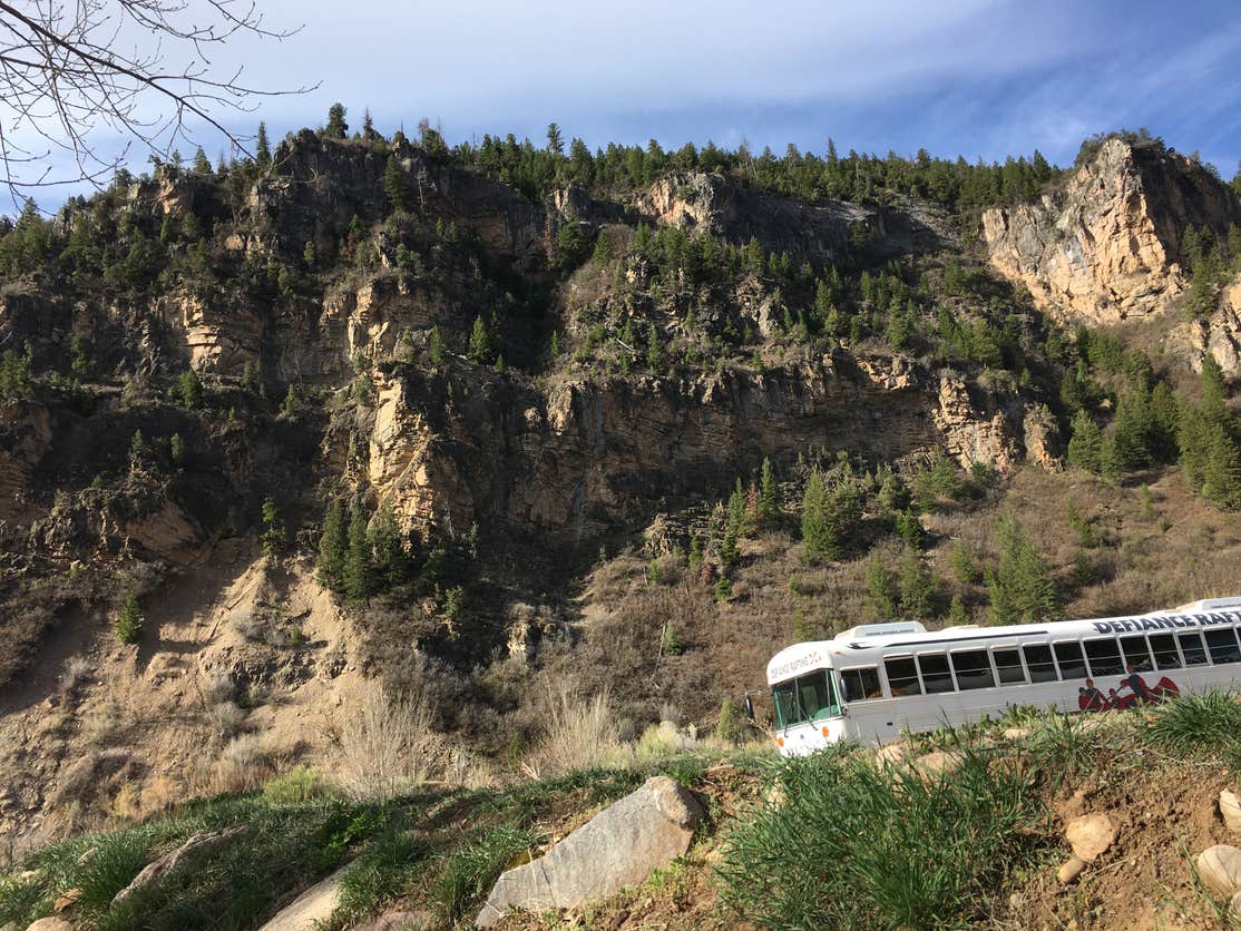 White bus in front of a peak at Golden City Clear RV Park