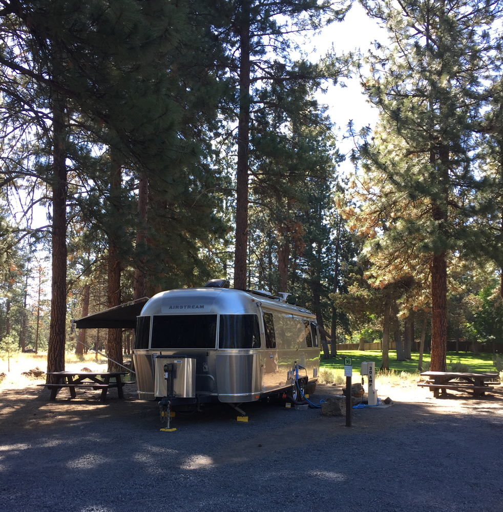Site 16. There are a row of RV back in sites from 1-16. All have hookups and 30 or 50 power. 

At site 16 you can see the open space in the back of the site. There is a trail that runs to the right of this site through the open space to the movie theatre, pub and restaurant. This is an easy 5 minute walk. 