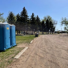 porti potty’s available and flush toilets in the white building