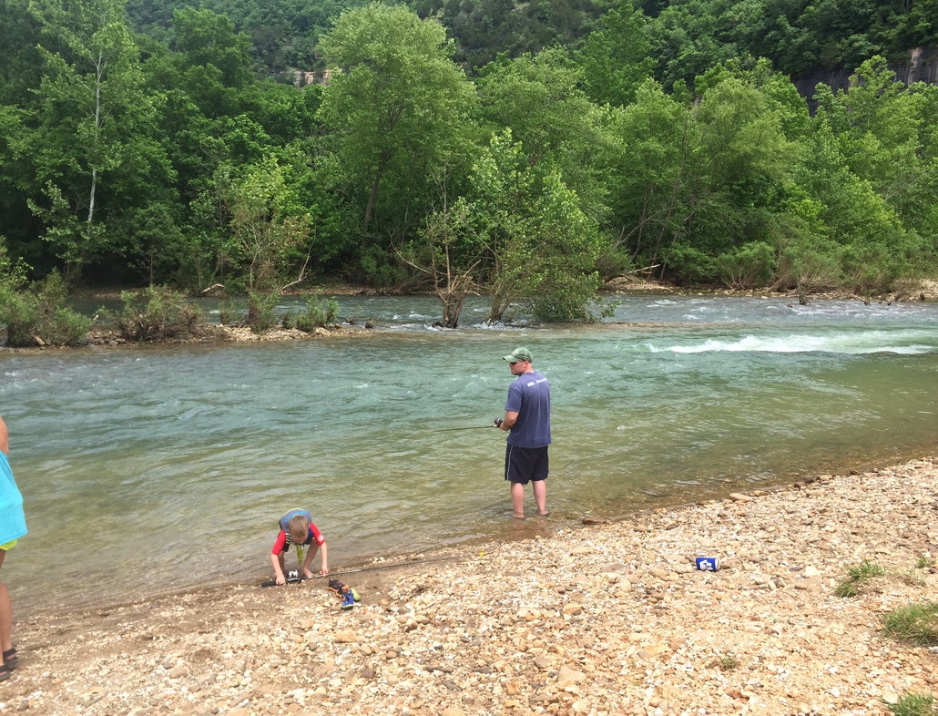 A family fishes on the shore of a river near Mill Creek Campground