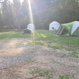 The tent area and two yurts along the pond