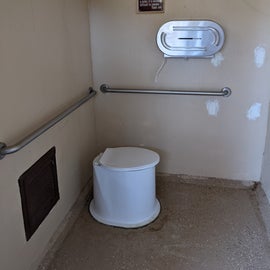 The pit toilet across from Site 24