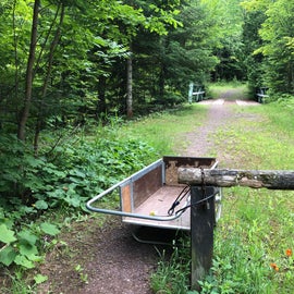 The bin is for the people staying at the cabin but keep walking past it and you will find the hiking trail