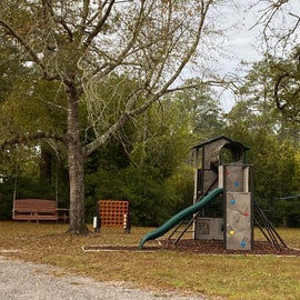 A relatively new kid's playlet with oversized plink and corn hole, along with a number of benches and swings to relax on