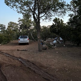 wider view of campsite with car next to it