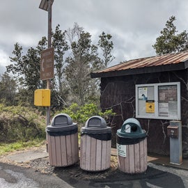 Pit toilet with trash and recycling.