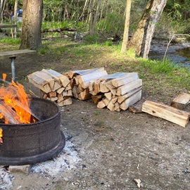 Fire going with wood from the camp store.