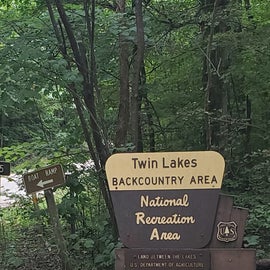 At the sign, go straight, or right at the fork to the campground. There are some very primitive campsites down by the boat ramp, and those are reviewed under the other Twin Lakes listing