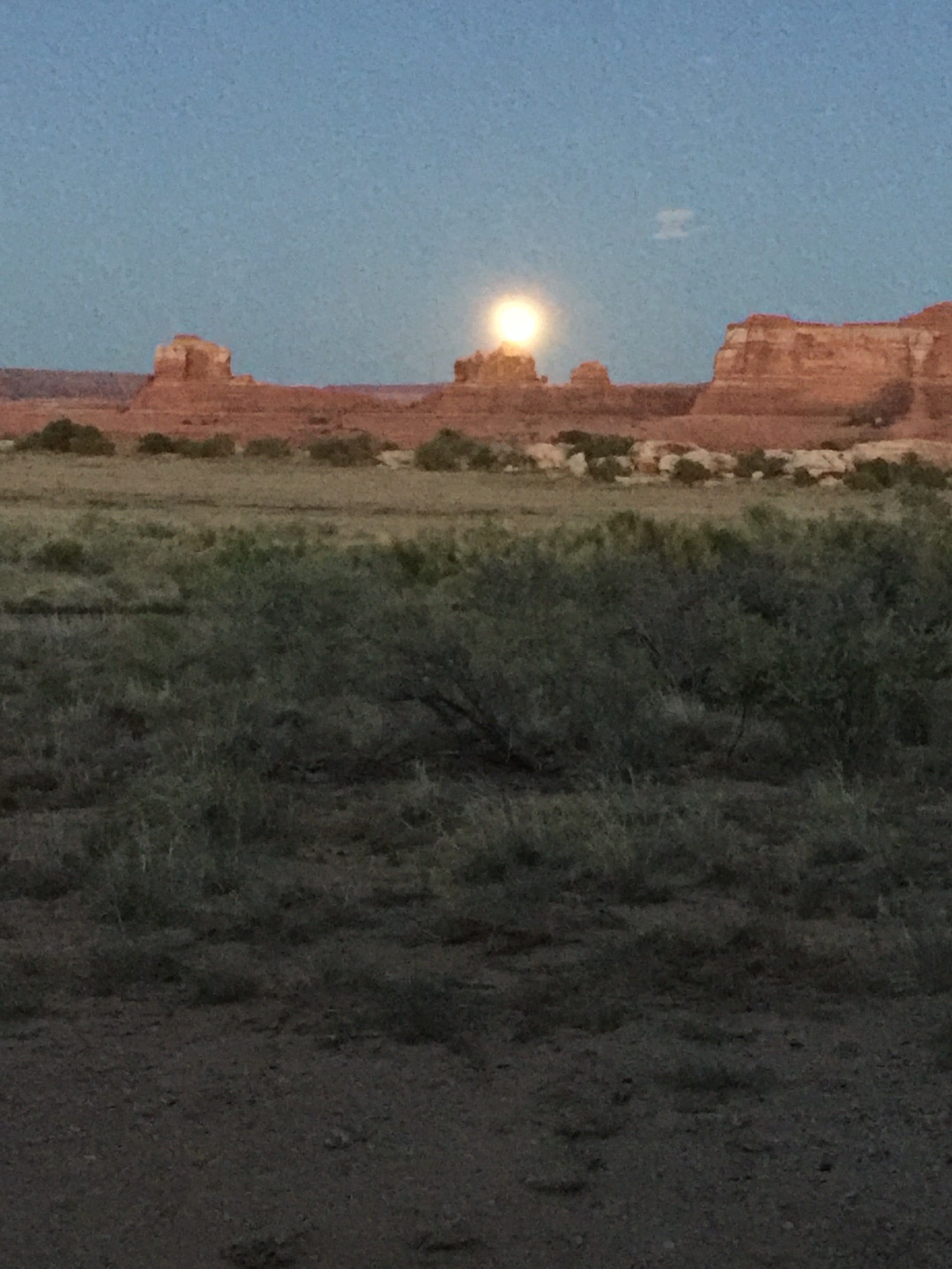 Perfect view of moon rising through the heel of the wooden shoe arch 